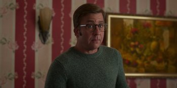 Movie still from “A Christmas Story Christmas” (2022), directed by Clay Kaytis – A man in a green sweater looking at the camera; Medium shot, Over the shoulder angle