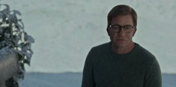 Movie still from “A Christmas Story Christmas” (2022), directed by Clay Kaytis – A man wearing glasses and a green sweater; Medium shot, Over the shoulder angle
