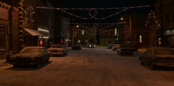 Movie still from “A Christmas Story Christmas” (2022), directed by Clay Kaytis – Cars parked on the side of the street at night; Extreme Wide shot, High angle