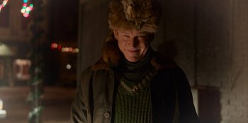 Movie still from “A Christmas Story Christmas” (2022), directed by Clay Kaytis – A man wearing a fur hat and a sweater; Close Up shot, Low angle