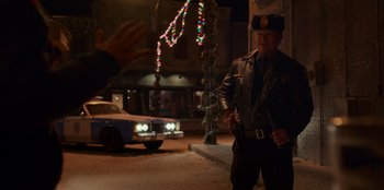 Movie still from “A Christmas Story Christmas” (2022), directed by Clay Kaytis – A police officer standing on the side of the street; Medium shot, Over the shoulder angle
