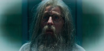 Movie still from “A Christmas Story Christmas” (2022), directed by Clay Kaytis – A man with long hair and a long beard wearing glasses; Close Up shot, Low angle