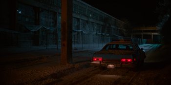 Movie still from “A Christmas Story Christmas” (2022), directed by Clay Kaytis – A car parked on the side of the road at night; Extreme Wide shot, High angle