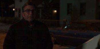 Movie still from “A Christmas Story Christmas” (2022), directed by Clay Kaytis – An older man wearing glasses sitting in front of a window; Medium shot, Over the shoulder angle