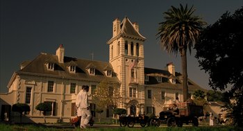 Movie still from “The Fall” (2006), directed by Tarsem Singh – Two people walking in front of a large white building; Extreme Wide shot, Low angle