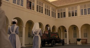 Movie still from “The Fall” (2006), directed by Tarsem Singh – A man and a woman are standing on the back of a truck; Extreme Wide shot, Low angle