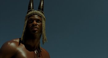 Movie still from “The Fall” (2006), directed by Tarsem Singh – A man wearing a headdress with horns on top of his head; Close Up shot, Low angle
