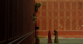 Movie still from “The Fall” (2006), directed by Tarsem Singh – Two women are standing in front of a wall; Extreme Wide shot, High angle