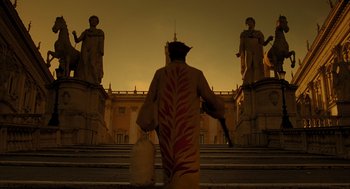 Movie still from “The Fall” (2006), directed by Tarsem Singh – A man in a costume walking down a set of steps; Wide shot, Low angle