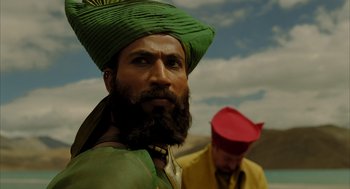 Movie still from “The Fall” (2006), directed by Tarsem Singh – A man with a beard and a green turban on his head; Close Up shot, Low angle