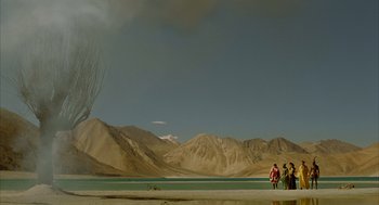 Movie still from “The Fall” (2006), directed by Tarsem Singh – A group of people standing on top of a sandy beach; Extreme Wide shot, Low angle