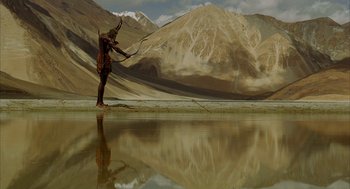 Movie still from “The Fall” (2006), directed by Tarsem Singh – A man is standing in the middle of a body of water; Extreme Wide shot, Low angle