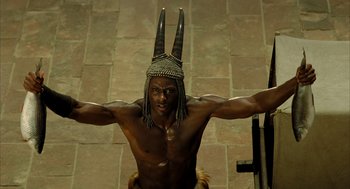 Movie still from “The Fall” (2006), directed by Tarsem Singh – A man with a headdress on his head; Medium shot, High angle