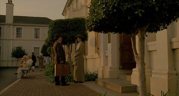 Movie still from “The Fall” (2006), directed by Tarsem Singh – A man and a woman standing on a sidewalk; Wide shot, Low angle