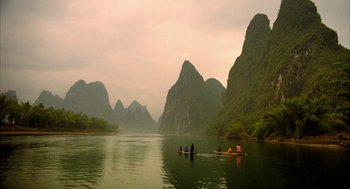 Movie still from “The Fall” (2006), directed by Tarsem Singh – A group of people in a boat on a body of water; Extreme Wide shot, High angle