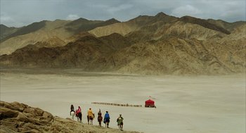 Movie still from “The Fall” (2006), directed by Tarsem Singh – A group of people riding horses in the desert; Extreme Wide shot, High angle