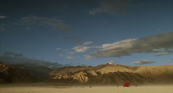 Movie still from “The Fall” (2006), directed by Tarsem Singh – A red truck is parked in the middle of the desert; Extreme Wide shot, Low angle