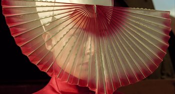 Movie still from “The Fall” (2006), directed by Tarsem Singh – A person holding a fan in their hand; Extreme Close Up shot, Low angle