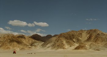 Movie still from “The Fall” (2006), directed by Tarsem Singh – A group of people walking across a desert; Extreme Wide shot, High angle