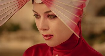 Movie still from “The Fall” (2006), directed by Tarsem Singh – A person wearing a hat with an umbrella; Close Up shot, Low angle