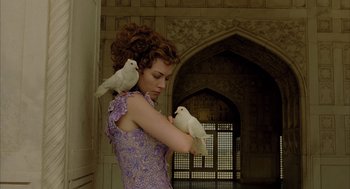 Movie still from “The Fall” (2006), directed by Tarsem Singh – A woman holding two white birds in her arms; Medium shot, Low angle
