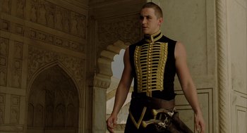 Movie still from “The Fall” (2006), directed by Tarsem Singh – A man in a black and gold uniform holding a sword; Medium shot, Low angle