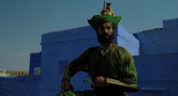 Movie still from “The Fall” (2006), directed by Tarsem Singh – A man dressed as a pirate in a green outfit; Medium shot, Low angle