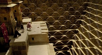 Movie still from “The Fall” (2006), directed by Tarsem Singh – Two people are standing on the steps of an amphitheater; Extreme Wide shot, High angle