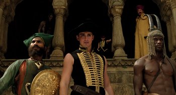 Movie still from “The Fall” (2006), directed by Tarsem Singh – A man in a black and gold outfit and a hat; Medium shot, Low angle