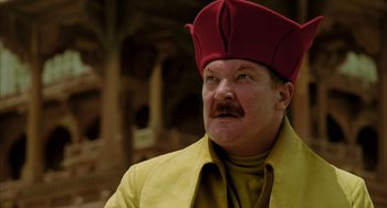 Movie still from “The Fall” (2006), directed by Tarsem Singh – A man with a mustache wearing a red hat; Close Up shot, Low angle