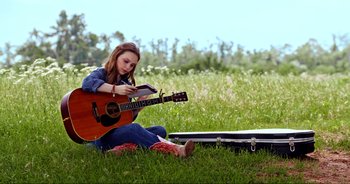 Movie still from “A Cowgirl's Song” (2022), directed by Timothy Armstrong – Medium shot, Low angle