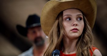 Movie still from “A Cowgirl's Song” (2022), directed by Timothy Armstrong – Close Up shot, Over the shoulder angle