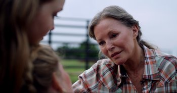Movie still from “A Cowgirl's Song” (2022), directed by Timothy Armstrong – An older woman and a young boy talking to each other; Close Up shot, Over the shoulder angle