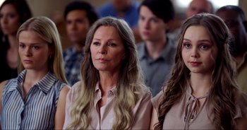 Movie still from “A Cowgirl's Song” (2022), directed by Timothy Armstrong – A group of people standing in front of each other; Close Up shot, Over the shoulder angle