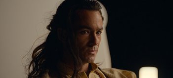 Movie still from “A Deadly Invitation” (2023), directed by J.M Cravioto – A person with long black hair; Close Up shot, High angle