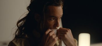 Movie still from “A Deadly Invitation” (2023), directed by J.M Cravioto – A person holding something in his mouth; Close Up shot, Low angle