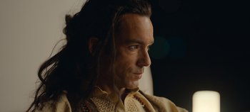 Movie still from “A Deadly Invitation” (2023), directed by J.M Cravioto – A person with long dreadlocks; Close Up shot, Low angle