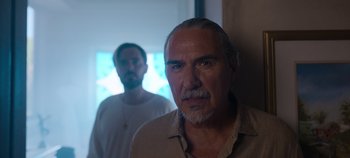 Movie still from “A Deadly Invitation” (2023), directed by J.M Cravioto – A man with a beard and mustache and a man with a beard and mustache; Close Up shot, Over the shoulder angle