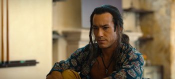 Movie still from “A Deadly Invitation” (2023), directed by J.M Cravioto – A person with long black hair; Close Up shot, Over the shoulder angle