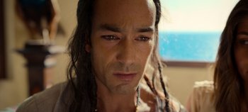 Movie still from “A Deadly Invitation” (2023), directed by J.M Cravioto – A person with long dreadlocks; Close Up shot, High angle