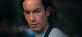 Movie still from “A Deadly Invitation” (2023), directed by J.M Cravioto – A person with long black hair; Close Up shot, Low angle