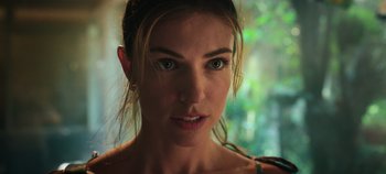 Movie still from “A Deadly Invitation” (2023), directed by J.M Cravioto – A woman's face in front of trees; Close Up shot, Low angle