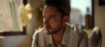 Movie still from “A Deadly Invitation” (2023), directed by J.M Cravioto – A person wearing a shirt; Close Up shot, Over the shoulder angle