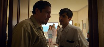 Movie still from “A Deadly Invitation” (2023), directed by J.M Cravioto – Two men standing next to each other in a room; Medium shot, Over the shoulder angle