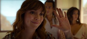 Movie still from “A Deadly Invitation” (2023), directed by J.M Cravioto – A person waving at the camera; Close Up shot, Over the shoulder angle