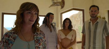 Movie still from “A Deadly Invitation” (2023), directed by J.M Cravioto – A woman standing next to a man and a woman; Medium shot, Over the shoulder angle