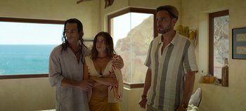 Movie still from “A Deadly Invitation” (2023), directed by J.M Cravioto – A group of people standing next to each other in front of a window; Medium shot, Over the shoulder angle