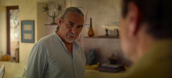 Movie still from “A Deadly Invitation” (2023), directed by J.M Cravioto – An older man looking at himself in the mirror; Close Up shot, Over the shoulder angle