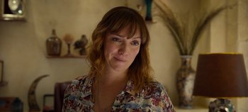 Movie still from “A Deadly Invitation” (2023), directed by J.M Cravioto – A person wearing a floral shirt; Close Up shot, Over the shoulder angle