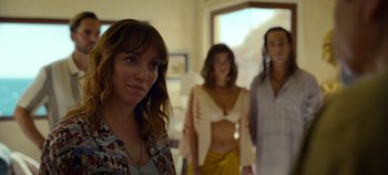 Movie still from “A Deadly Invitation” (2023), directed by J.M Cravioto – Two women and a man standing next to each other in a room; Medium shot, Over the shoulder angle